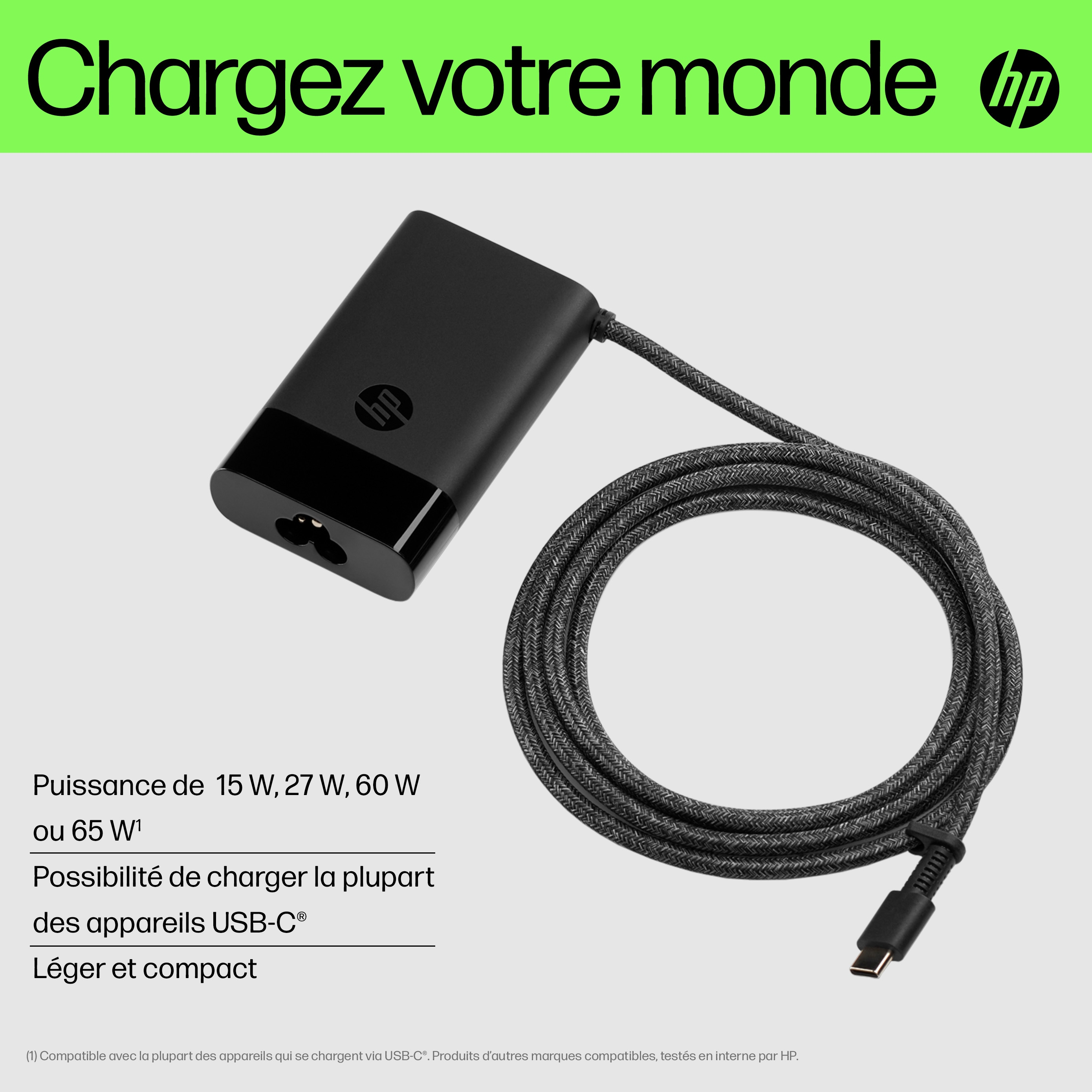 Black HP charger with cable coiled. The text says: Charge your world.