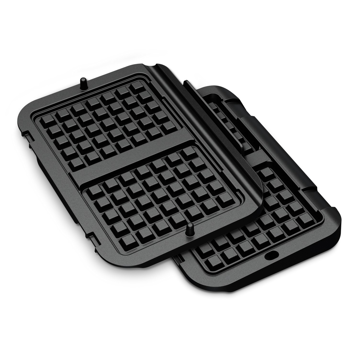 Plaques de gaufrier noires ouvertes. Des motifs de grille sont visibles dans chaque plaque.