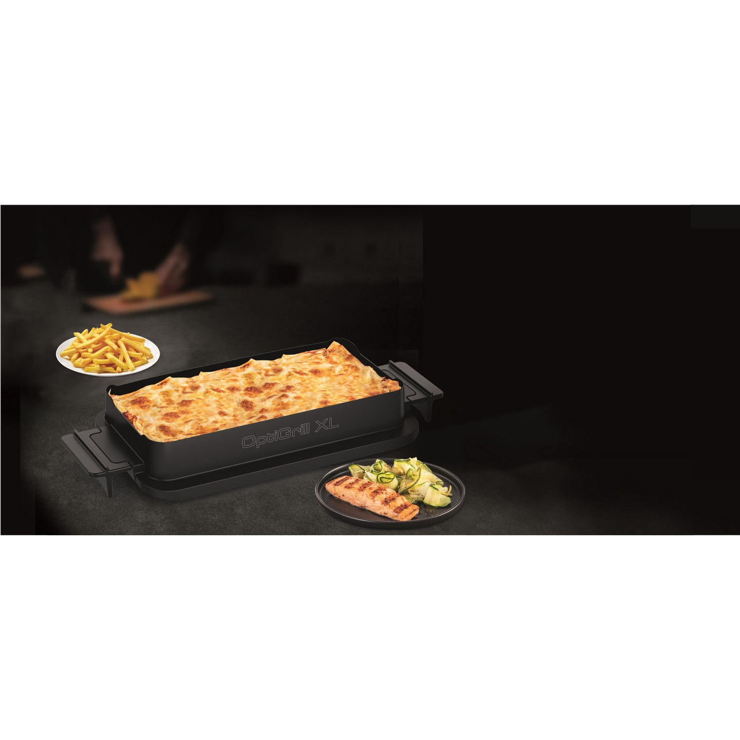 Black OptiGrill XL with lasagna, french fries, and salmon on a dark background.