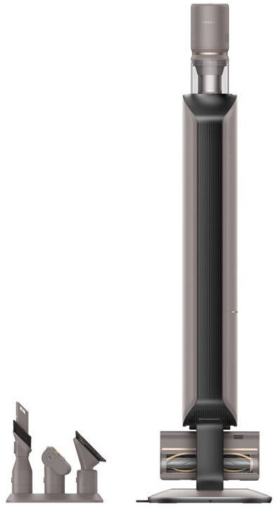 Szary odkurzacz z nasadkami. Nasadki są po lewej stronie. Białe tło.