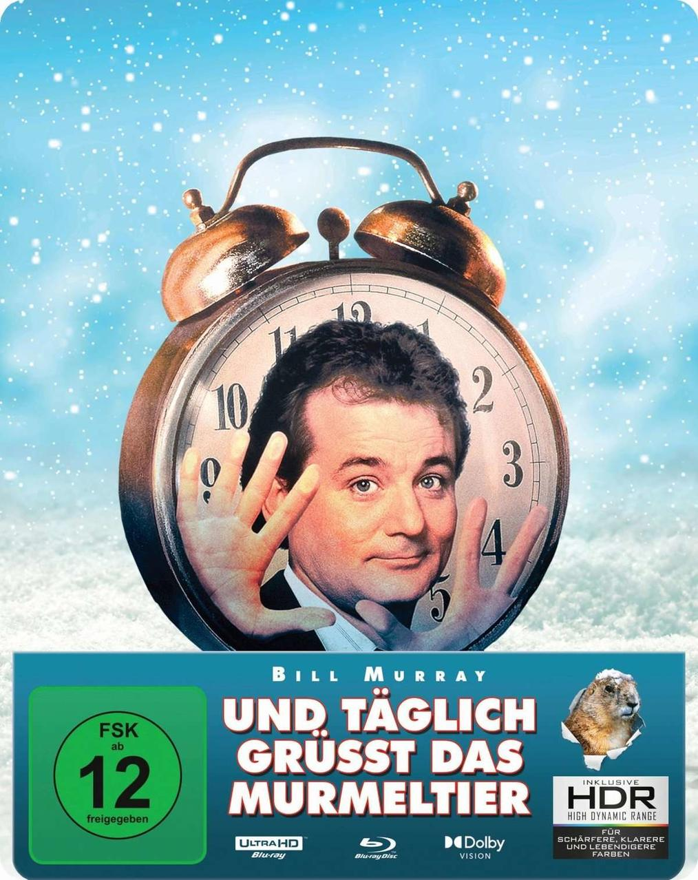 Filmcover: Bill Murrays Gesicht in einer Uhr, Schneehintergrund und der Filmtitel.