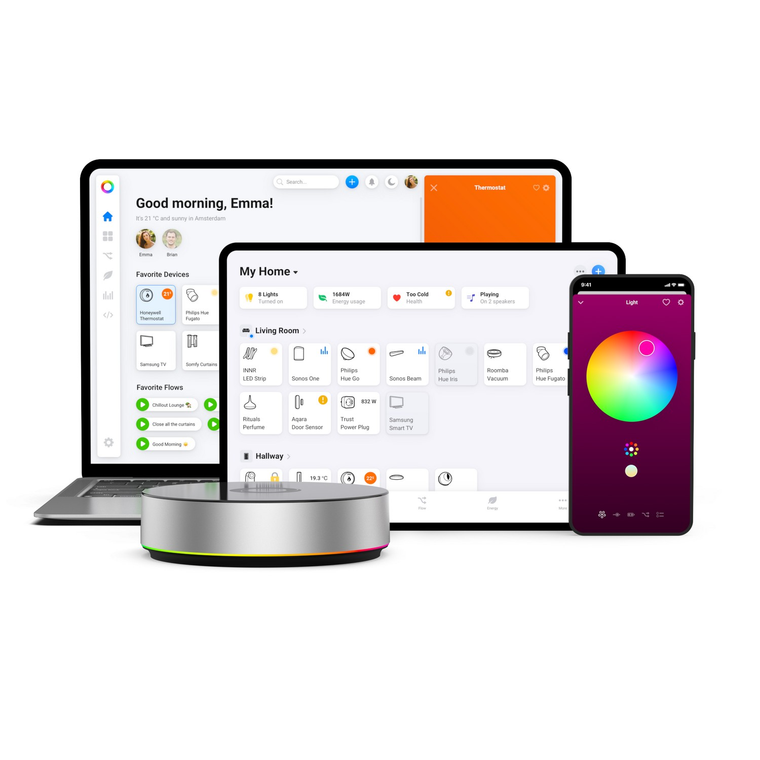 A laptop, tablet, and phone display a smart home interface, with a smart hub below them.