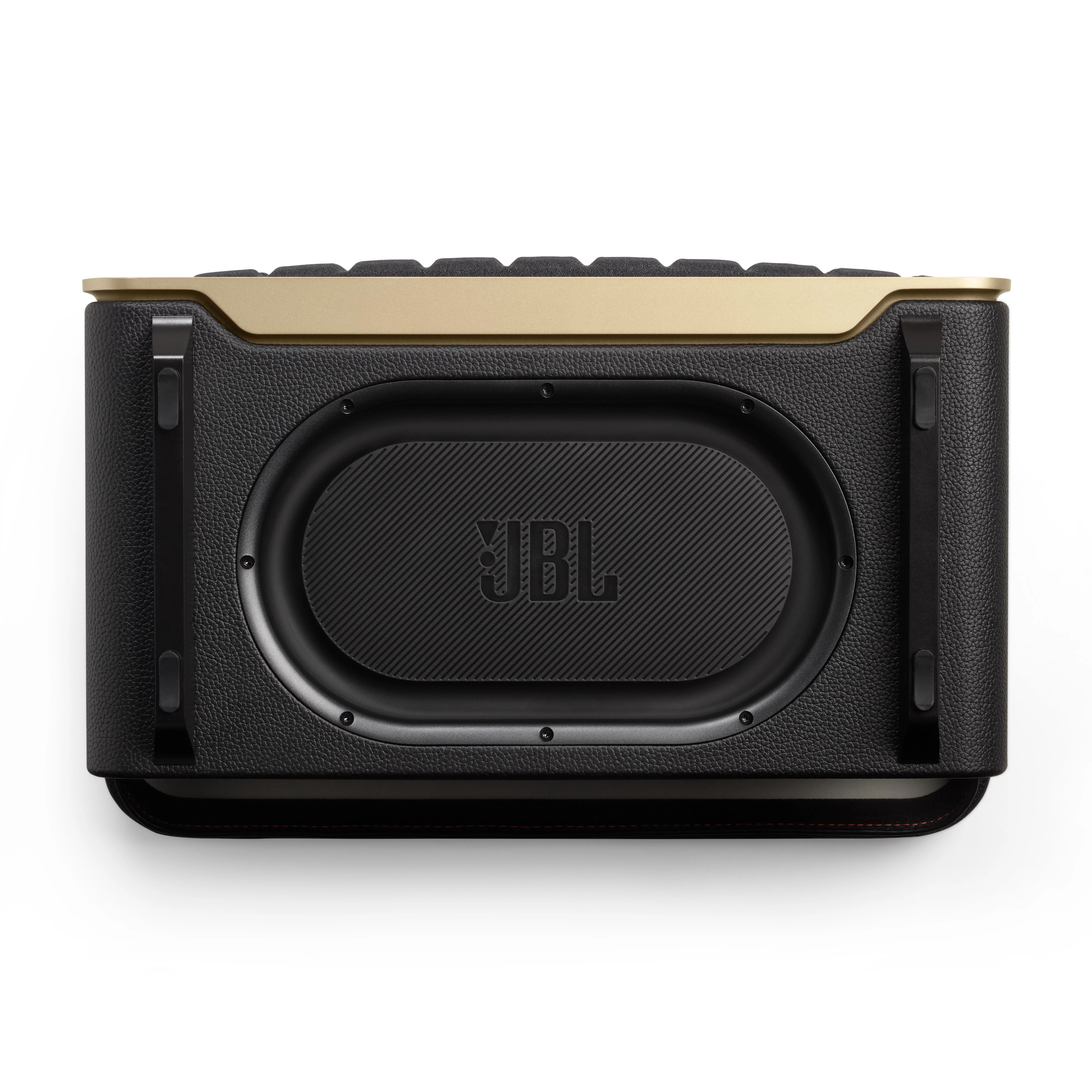 Altın kaplamalı ve siyah vurgulu siyah bir JBL hoparlörün yukarıdan görünümü.