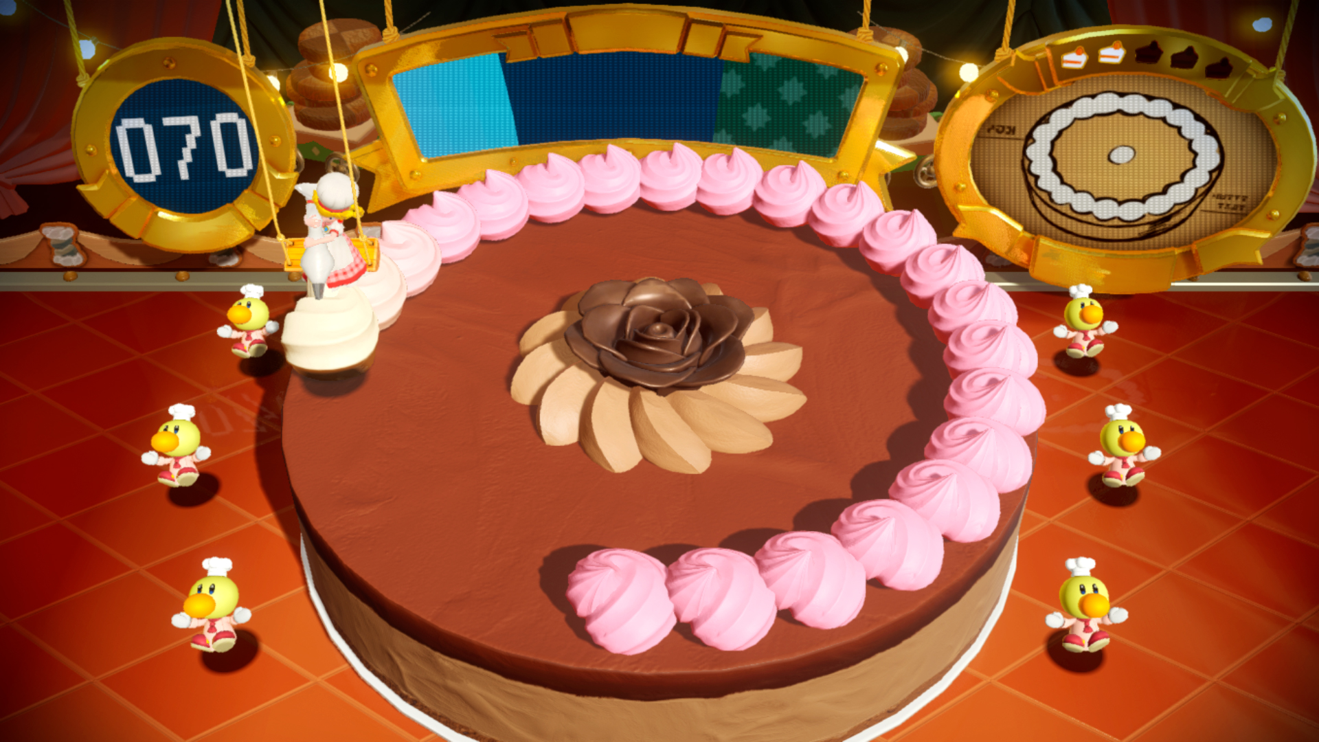 Pembe krema ve çikolata çiçeği ile süslenmiş bir kek, figürlerle.