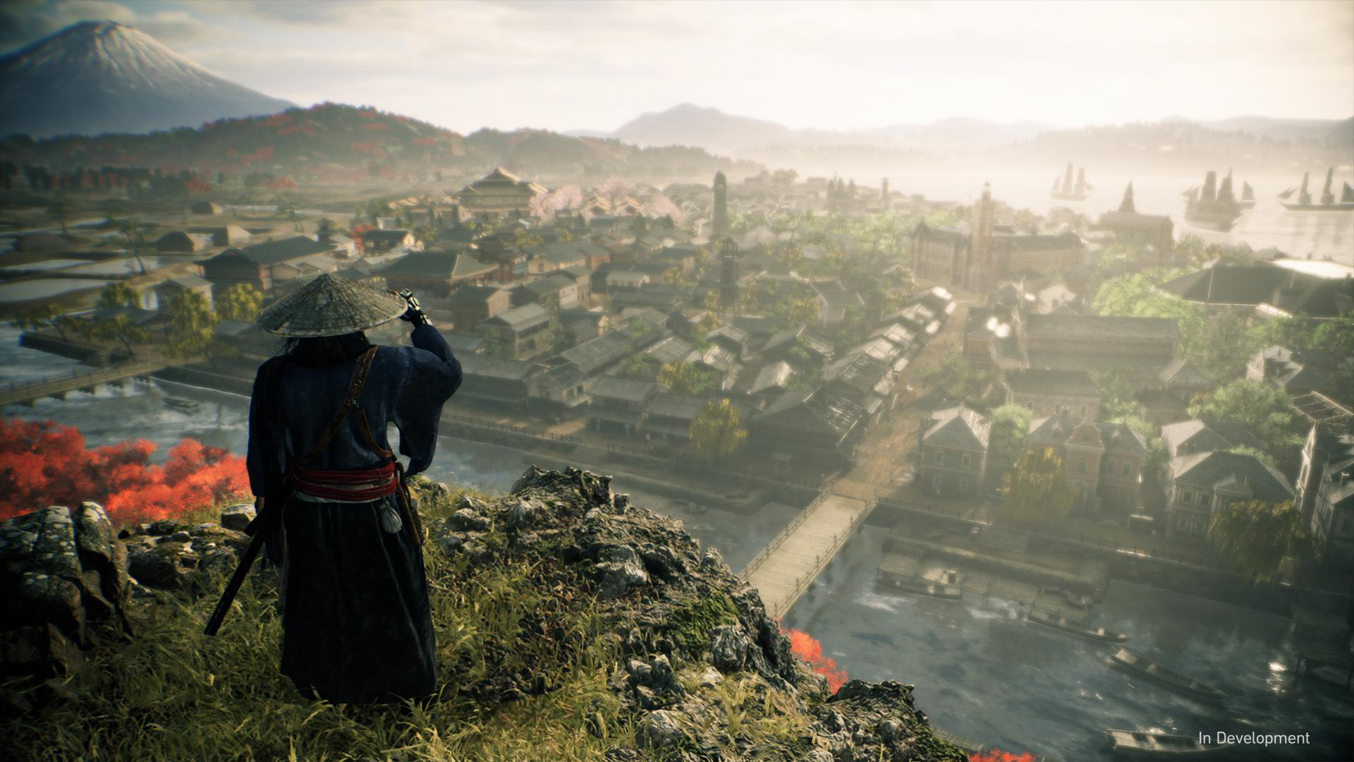 Ein Samurai steht auf einem Hügel und blickt auf eine detaillierte Stadt. Berge im Hintergrund, heller Himmel.