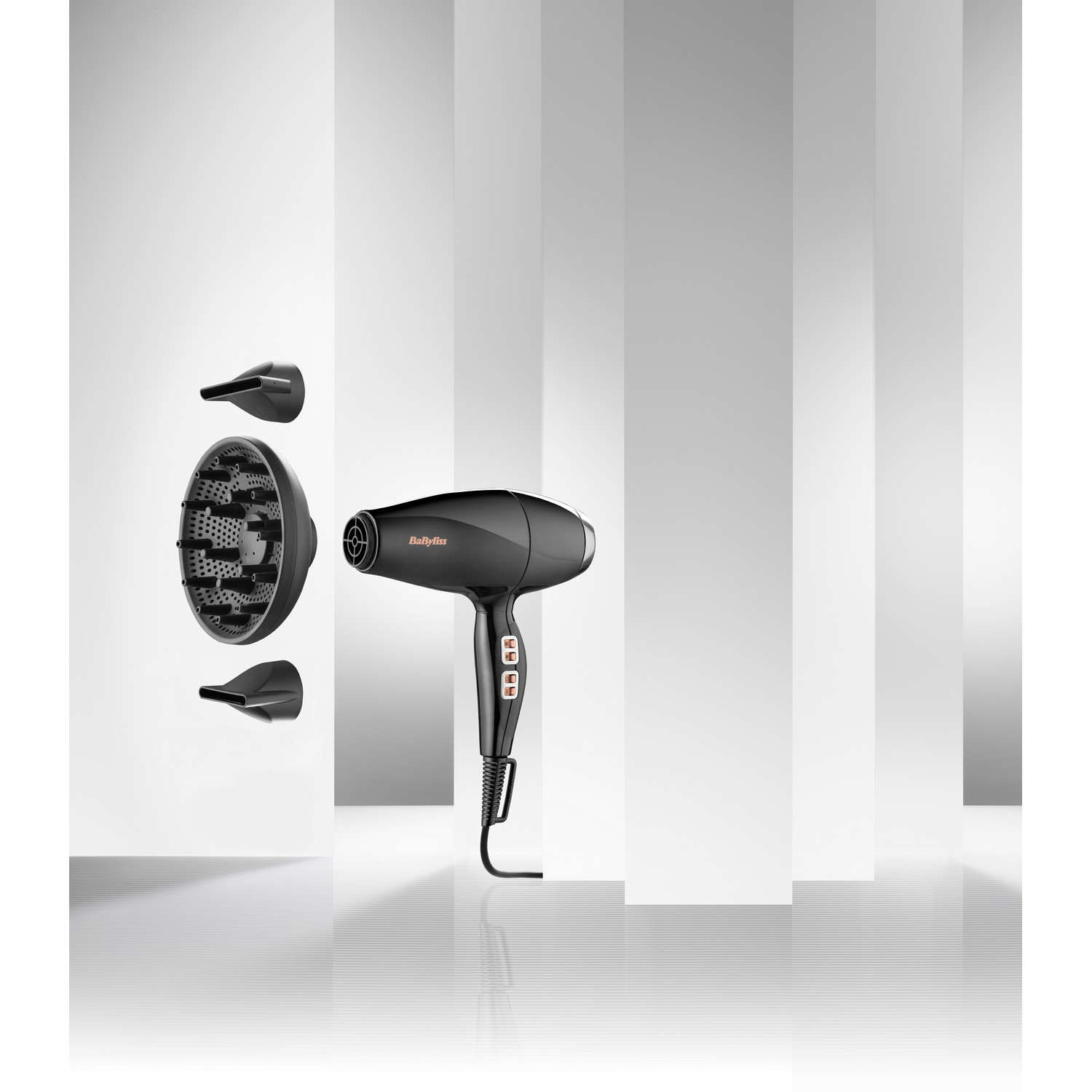 Sèche-cheveux noir avec accessoires sur fond blanc et gris rayé, et une poignée.