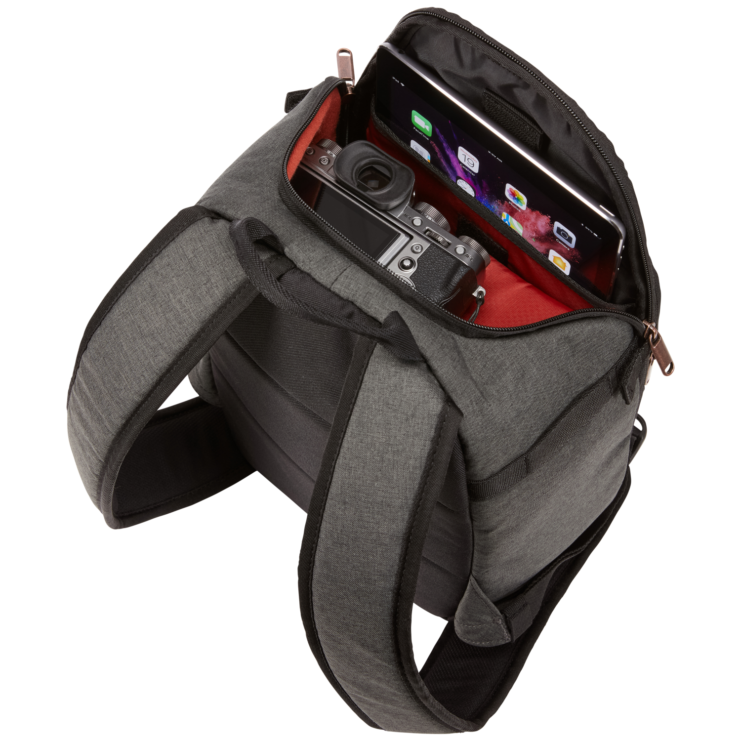Gray camera bag, opened, showing a camera, tablet, and red lining inside.