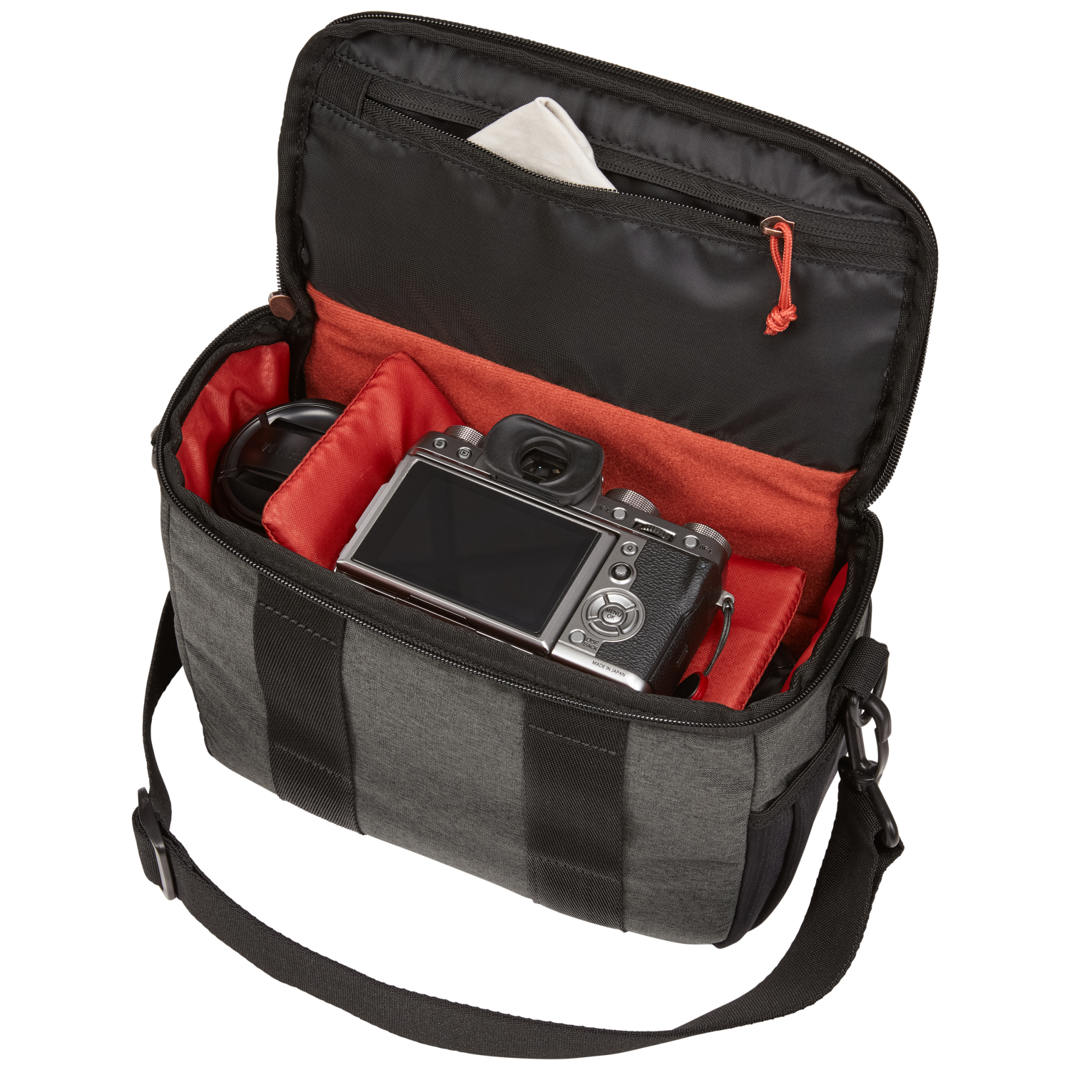Open grey camera bag with camera, lens and accessories inside.