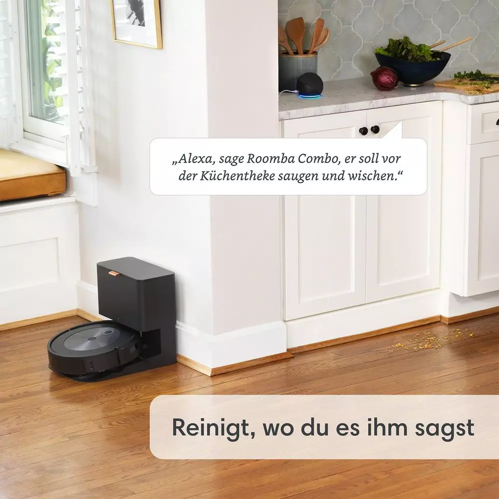 Ein Roomba-Roboterstaubsauger in einer Küche, mit Textanweisungen für Alexa.