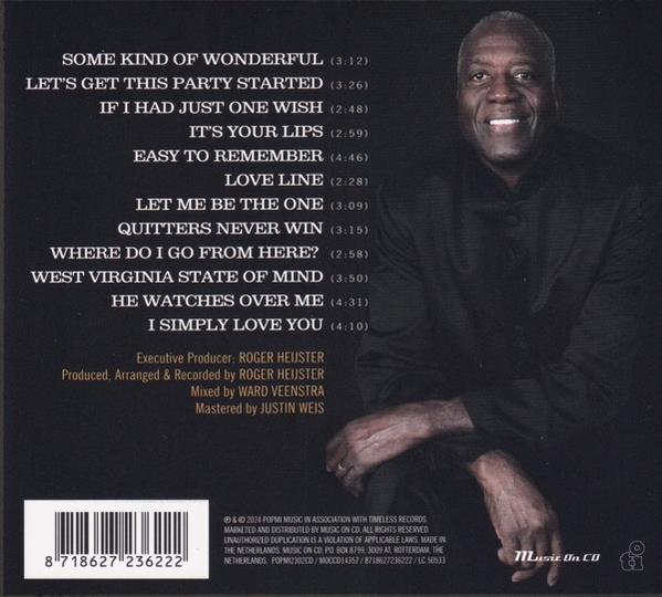 Albumcover mit lächelndem Mann, Songtiteln und Credits.