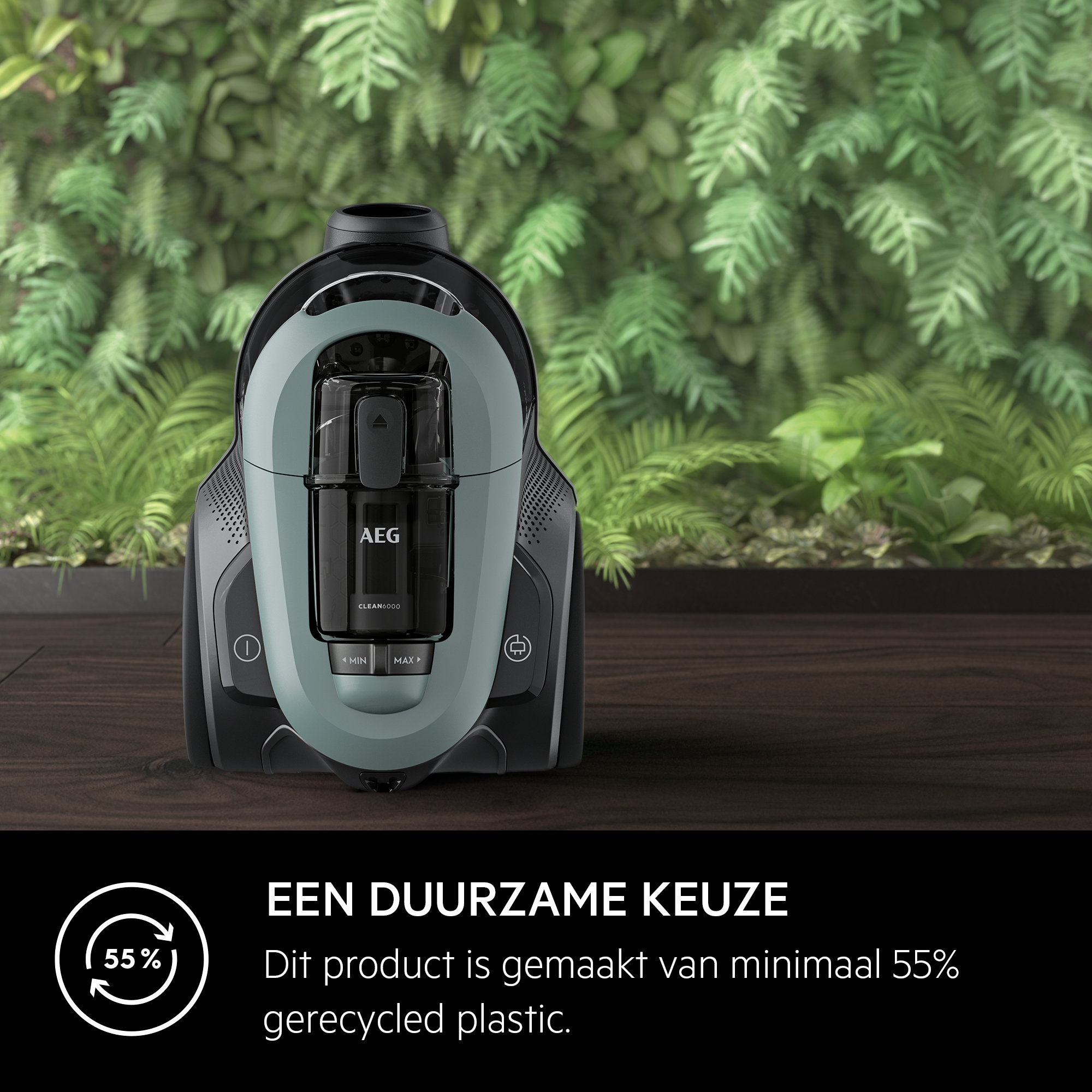A green and black vacuum cleaner. The background is a green wall.