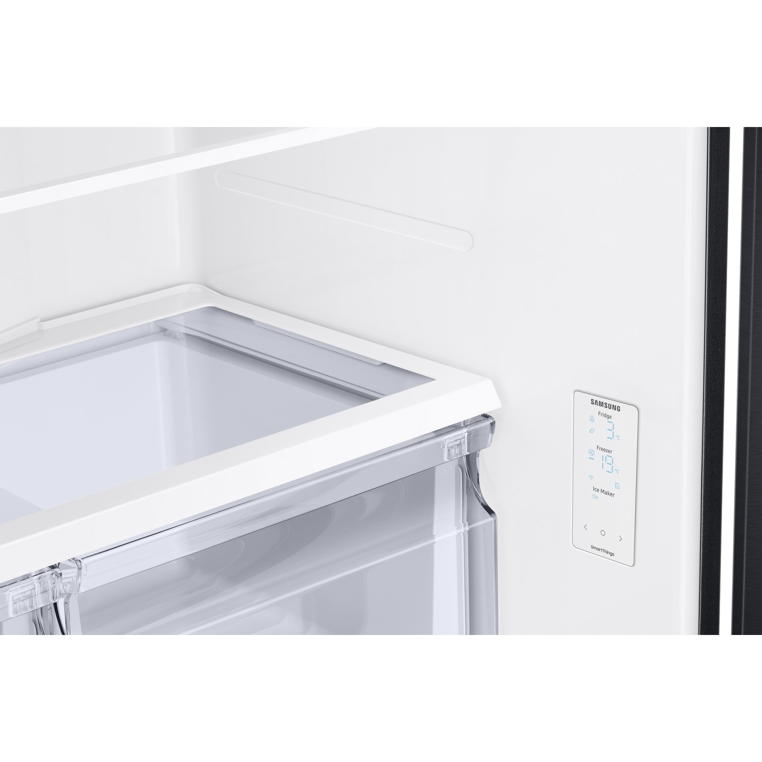 Inside a refrigerator, white interior, water dispenser, and temperature control.