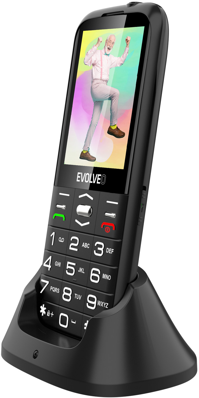 Fekete telefon állványon, táncoló férfit mutat a képernyőn.
