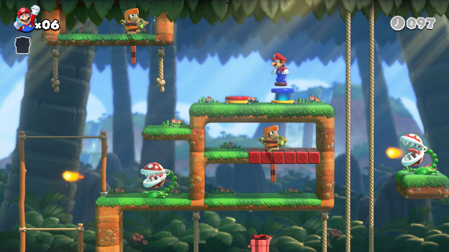 Zrzut ekranu z gry Super Mario. Mario na platformach, wrogowie, tło dżungli.