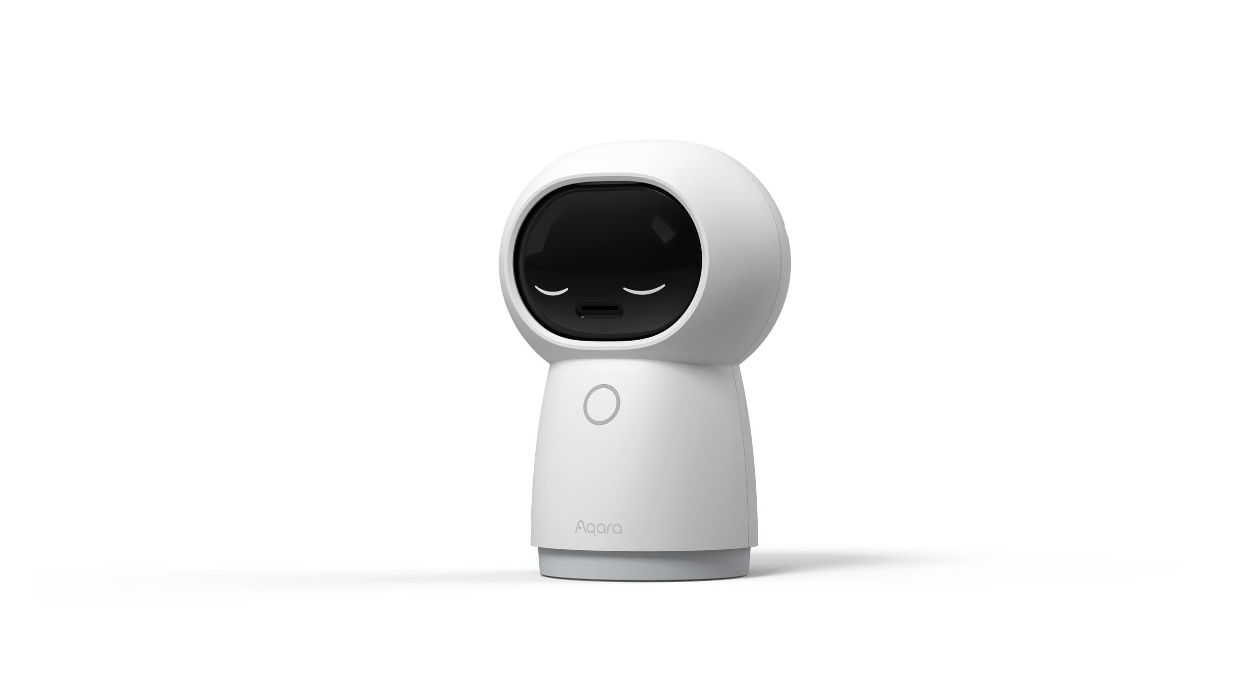 Ein weißer Roboter mit schwarzem Bildschirmgesicht und rundem, weißem Körper. Das Logo 'Aqara' ist auf der Basis.