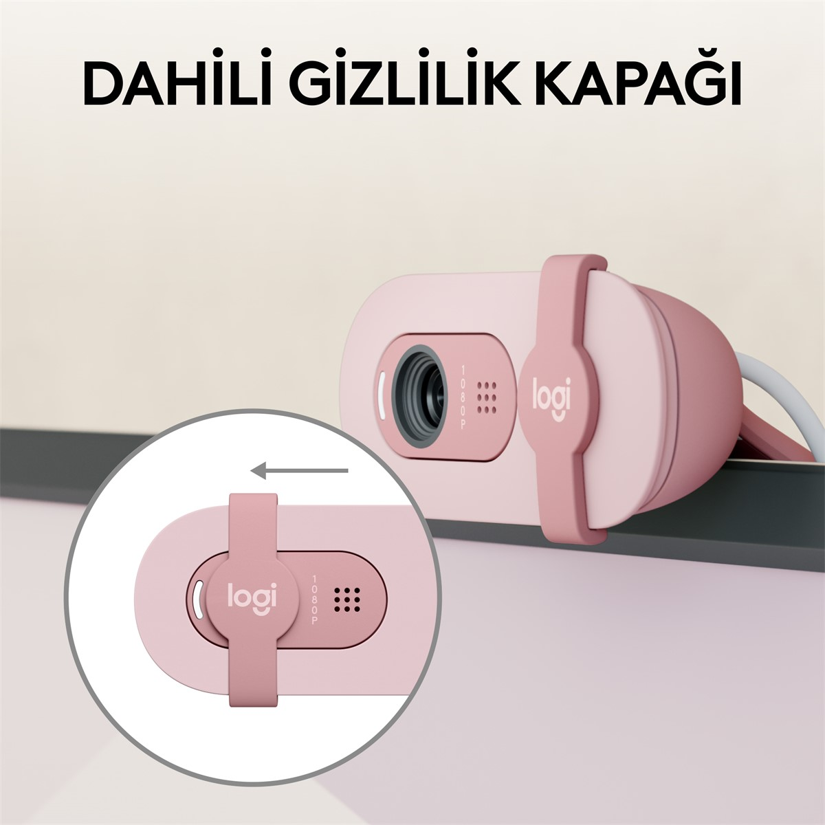 Pembe web kamerası, gizlilik kapağı ve kablo ile bir monitöre takılı şekilde gösteriliyor.