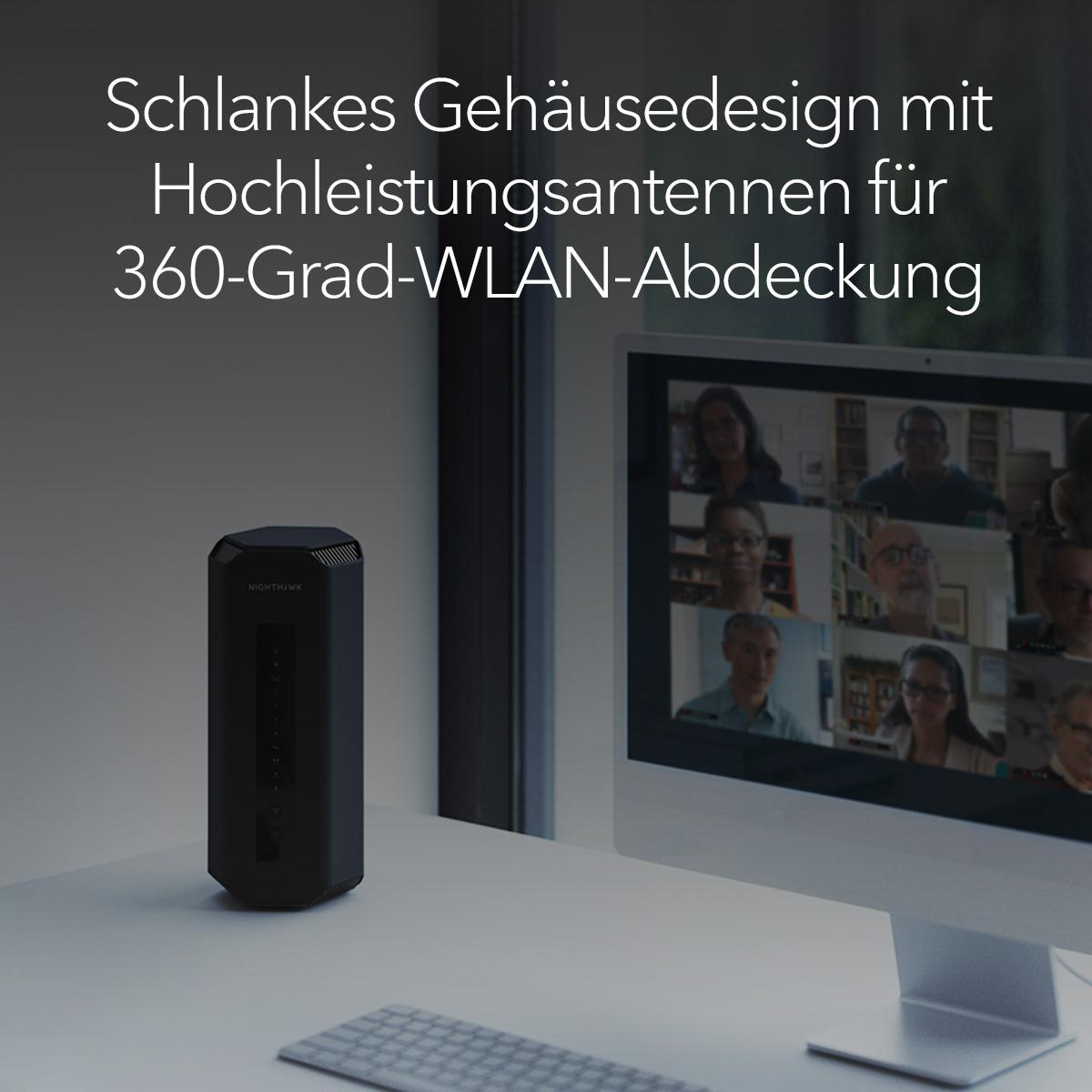 Ein WLAN-Router auf einem Schreibtisch neben einem Monitor.