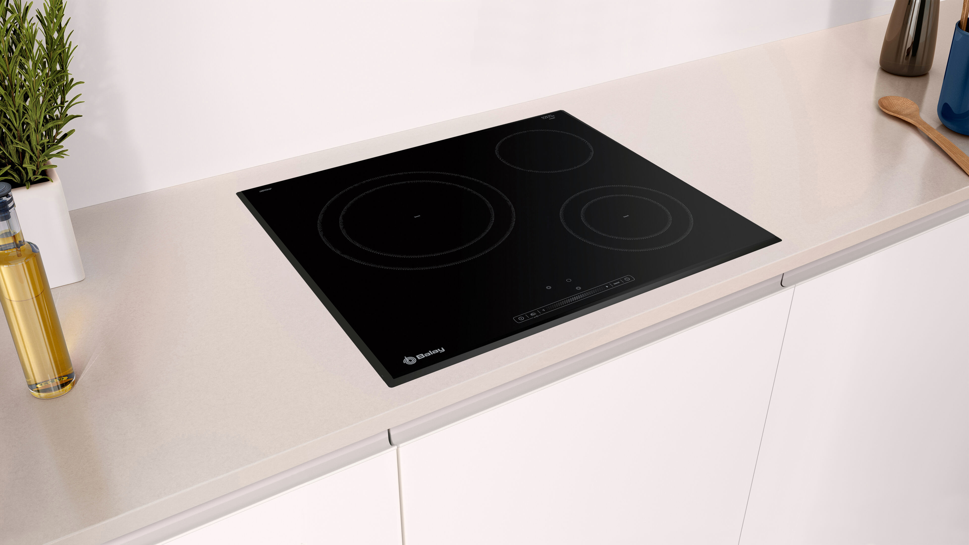 Placa de inducción negra sobre encimera blanca en un entorno de cocina.