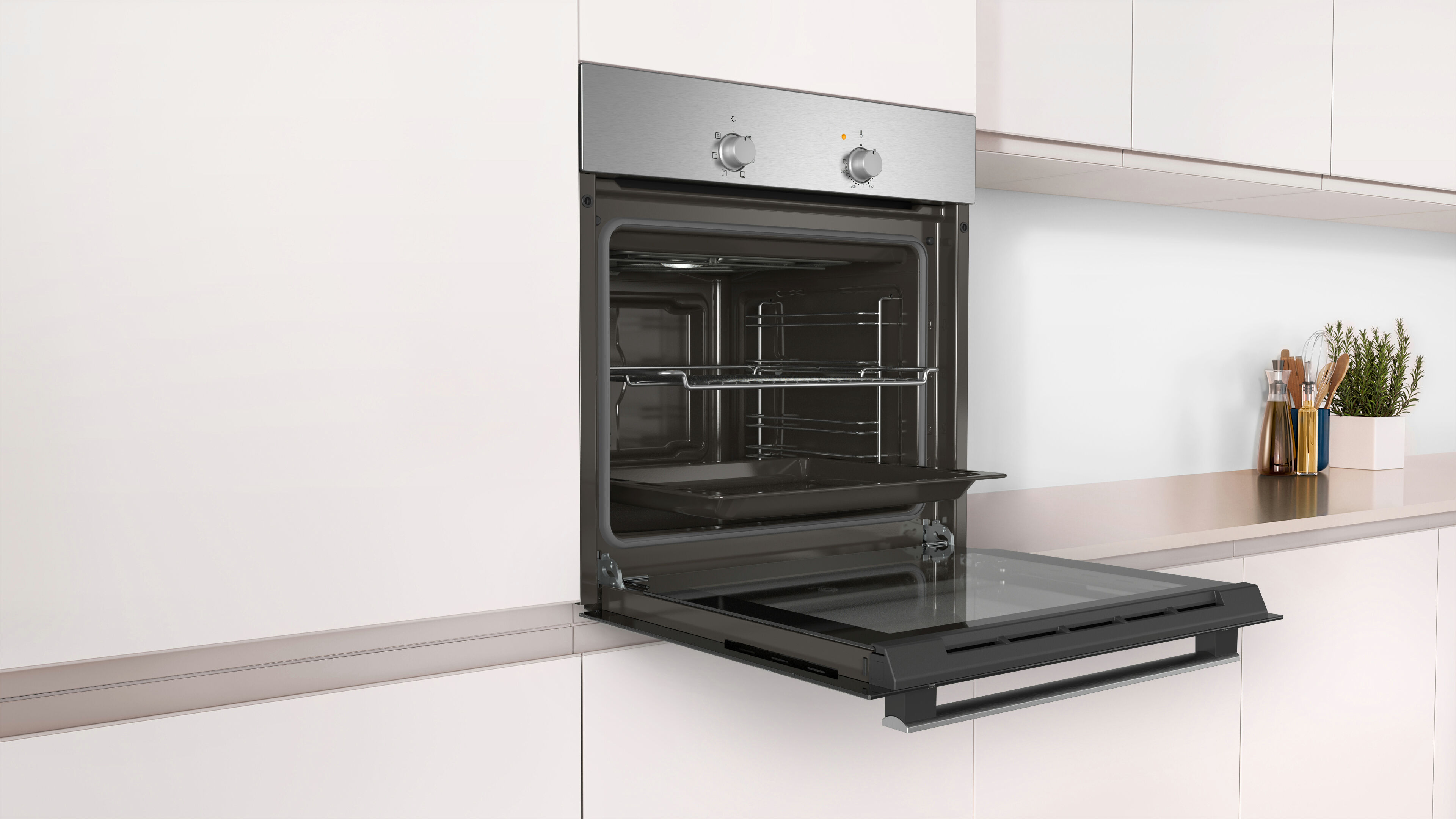 Un horno integrado en un armario de cocina blanco, puerta abierta, estantes e interior visibles.