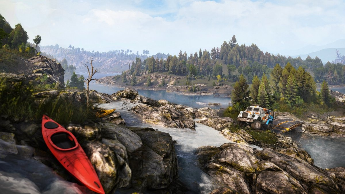 Scène de rivière avec un camion, des kayaks et des arbres.