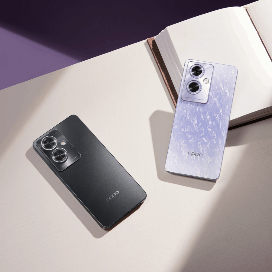 Dos teléfonos Oppo. Uno negro, otro morado claro. Ambos sobre una superficie blanca con un libro y fondo morado.