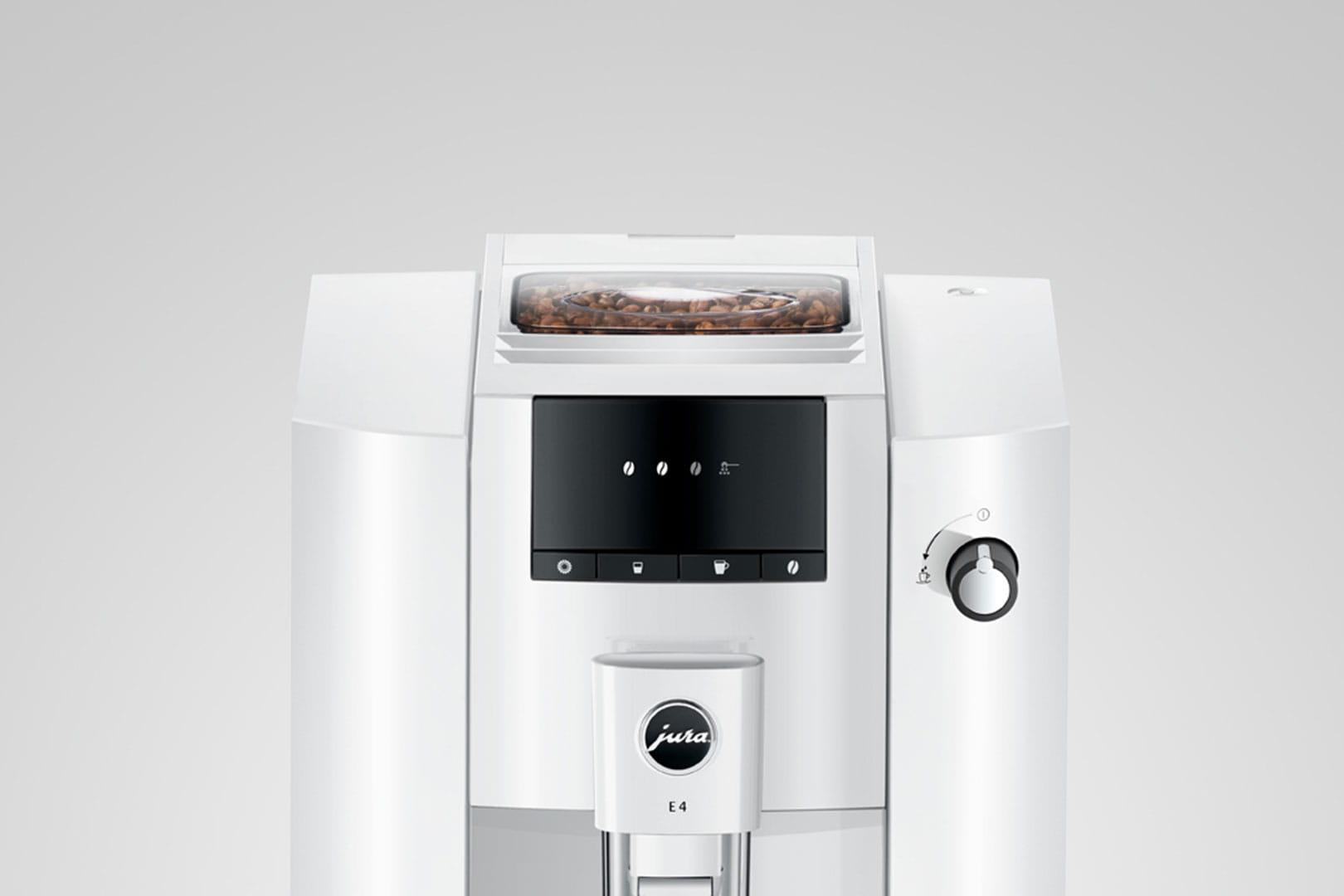 Weiße Jura E4 Kaffeemaschine, Draufsicht mit Kaffeebohnen. Schwarzes Display und Drehregler.