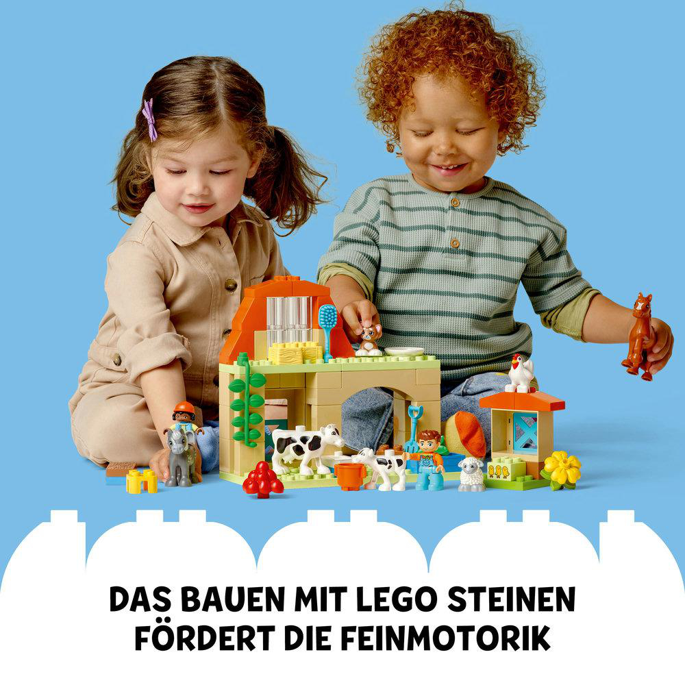 Zwei Kinder spielen mit Legosteinen und bauen eine Bauernhofszene.