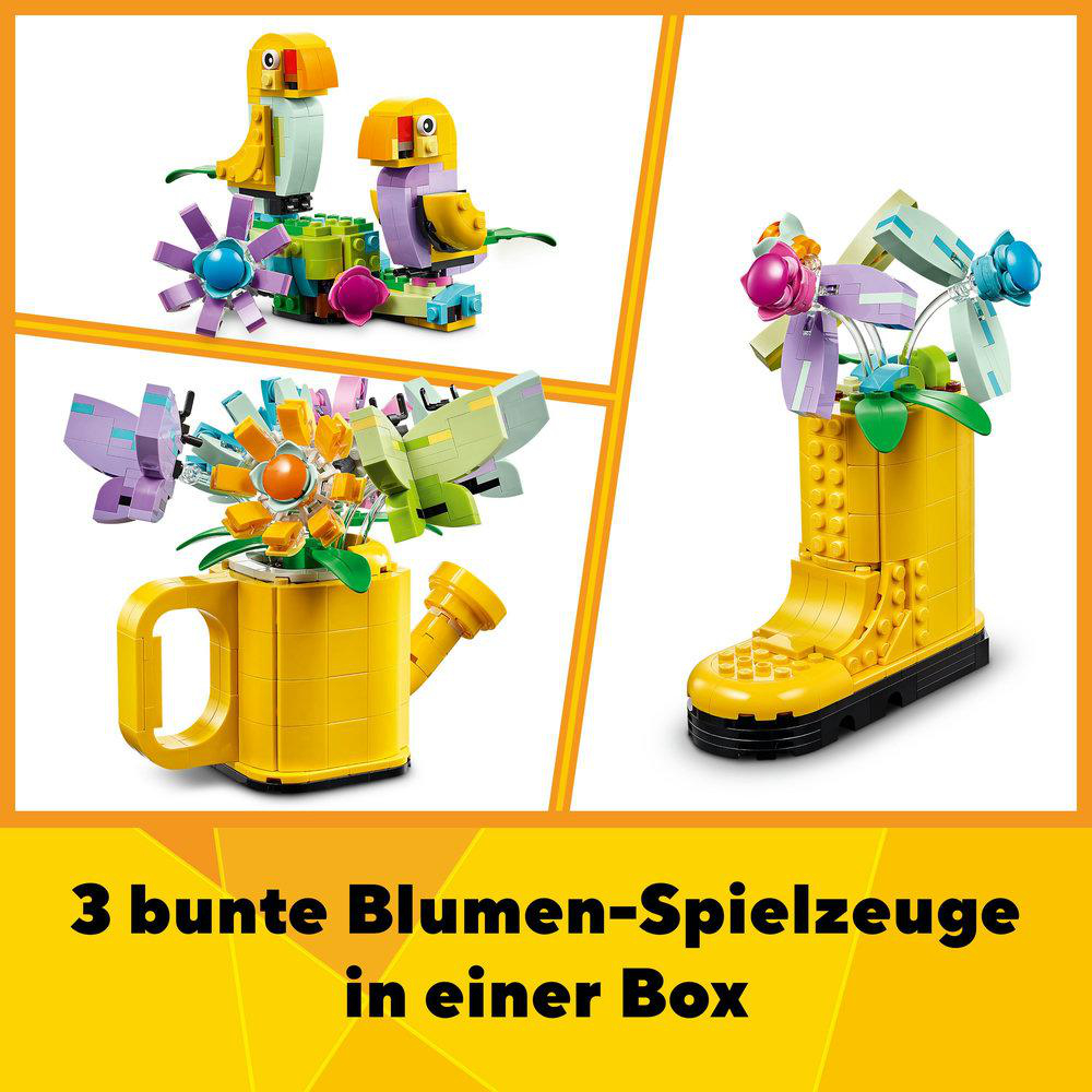 Drei bunte Lego-Blumenspielzeuge in gelber Gießkanne und Stiefeln auf weißer Fläche.