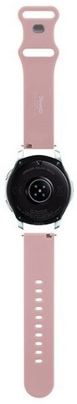 Różowy zegarek Suunto z różowymi paskami. Zegarek jest widziany od dołu, pokazując czujniki i szczegóły paska.