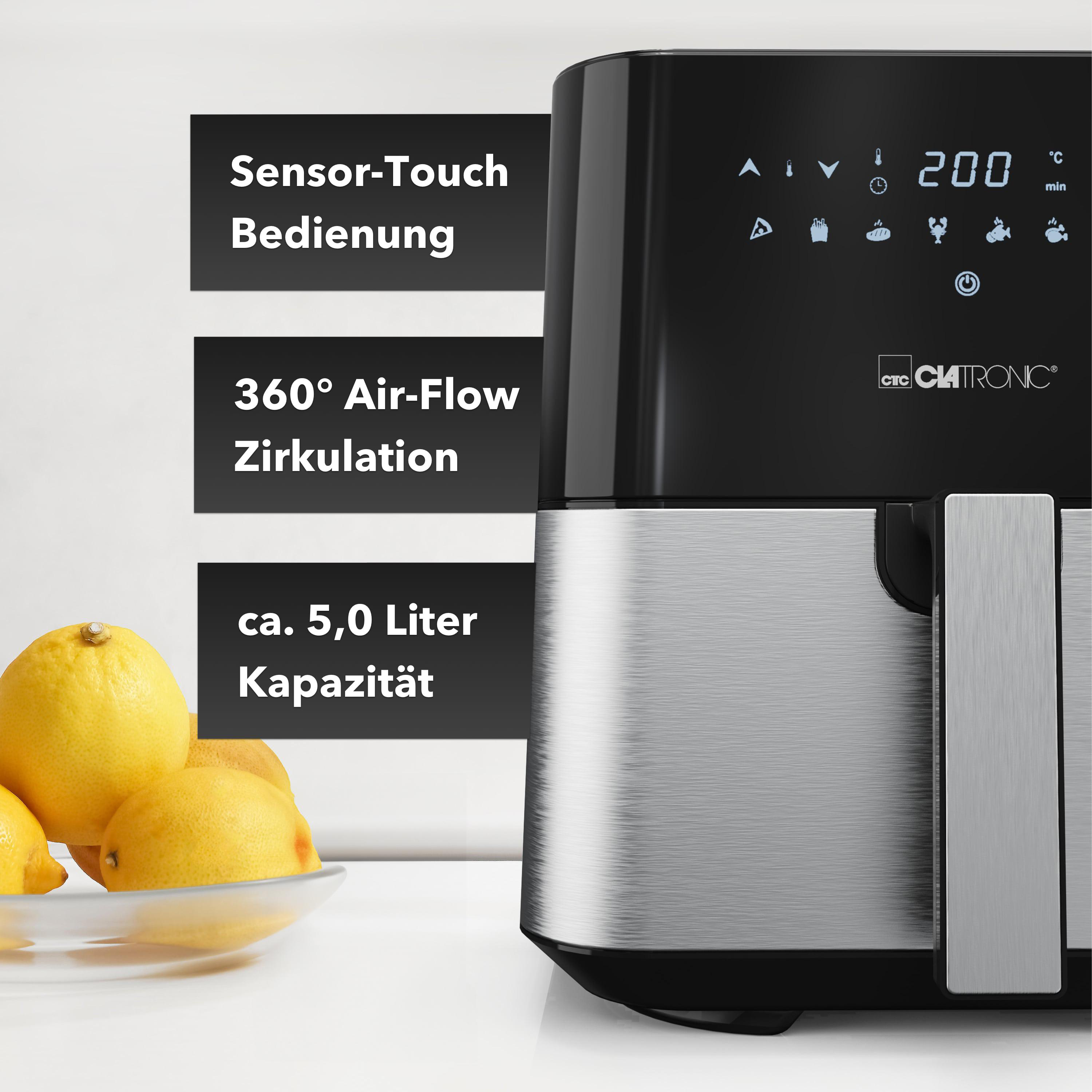 Schwarze Heißluftfritteuse mit Zitronen davor. Zeigt Bedienelemente und 200°C Temperatur.