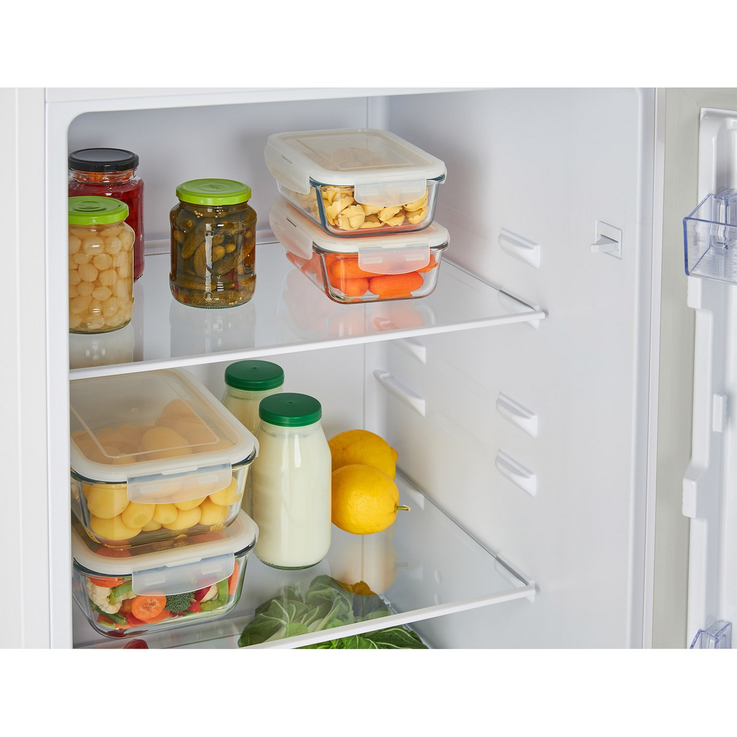 Refrigerator interior with food in glass containers and jars.