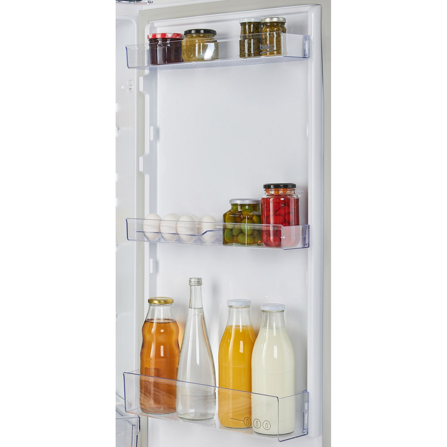 Inside of a refrigerator with shelves holding jars, bottles, and eggs.