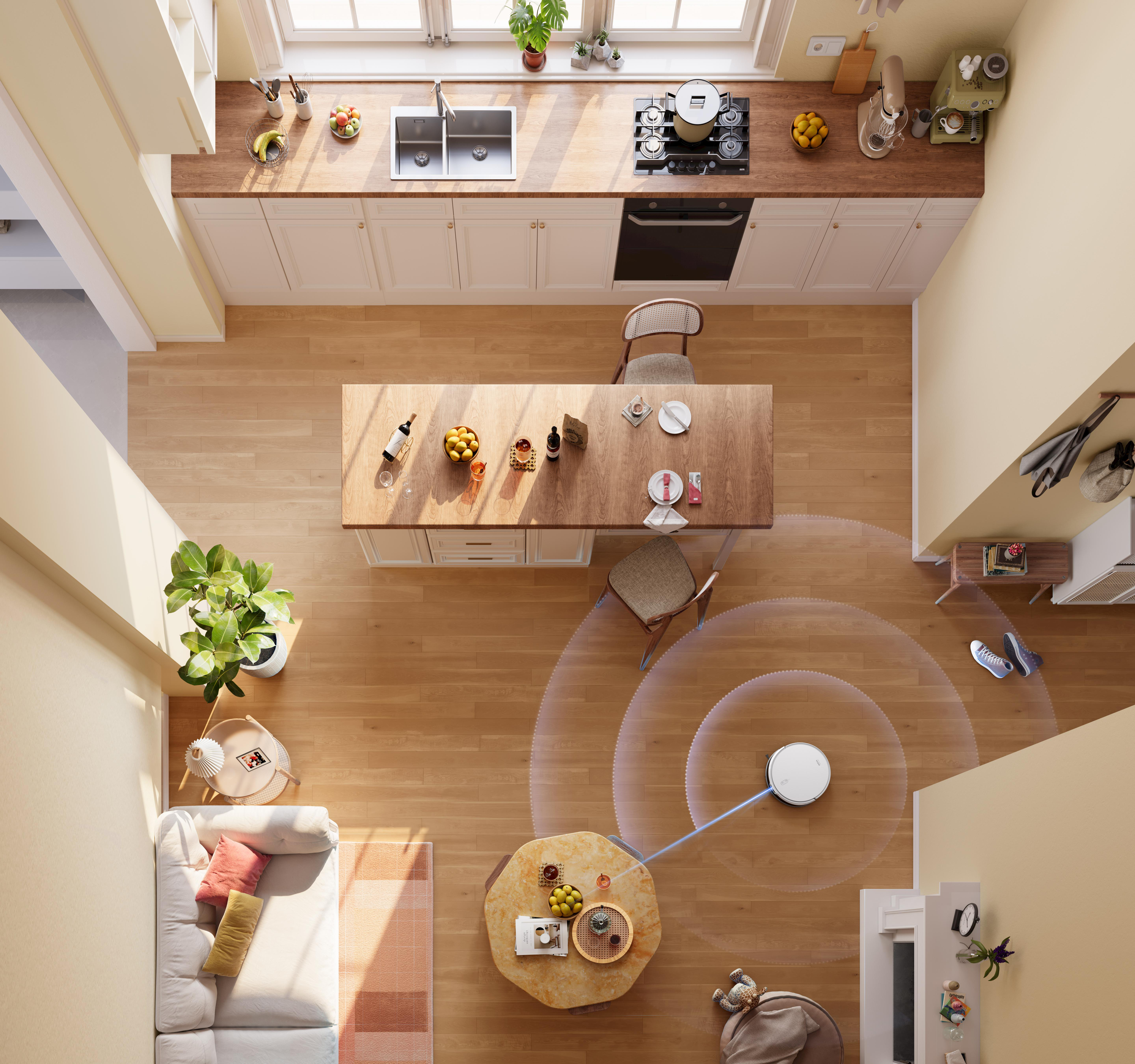 Draufsicht auf eine moderne Küche mit Holzböden, einem Roboter-Staubsauger und Möbeln.