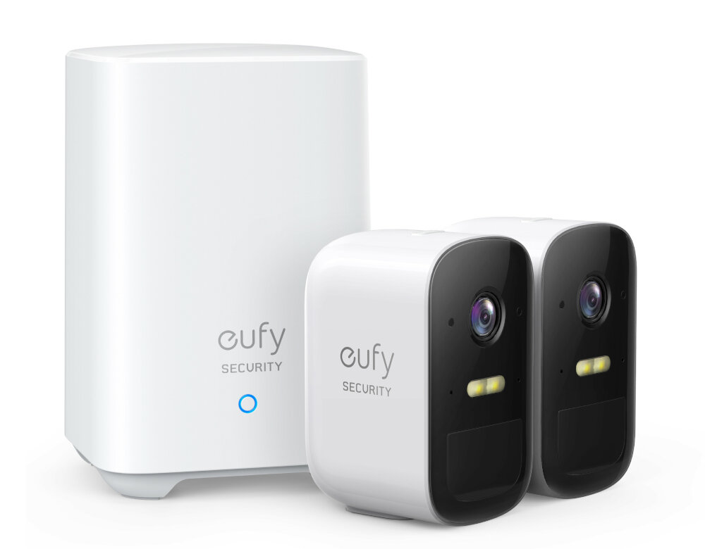 Dwie białe kamery bezpieczeństwa eufy z białą stacją bazową. Służą do bezpieczeństwa domu.