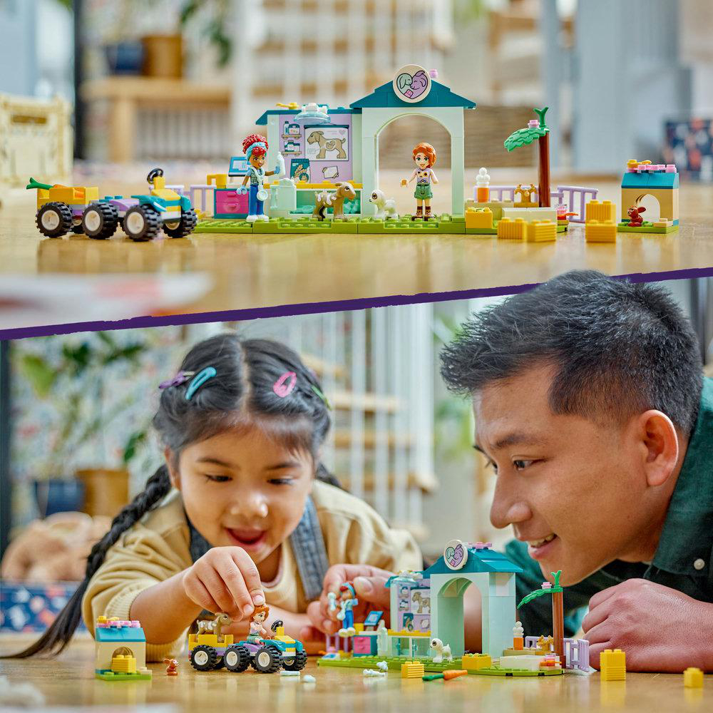 Ein Lego-Set zeigt eine Tierklinik, Figuren und Tiere. Ein Mädchen und ein Mann spielen damit.
