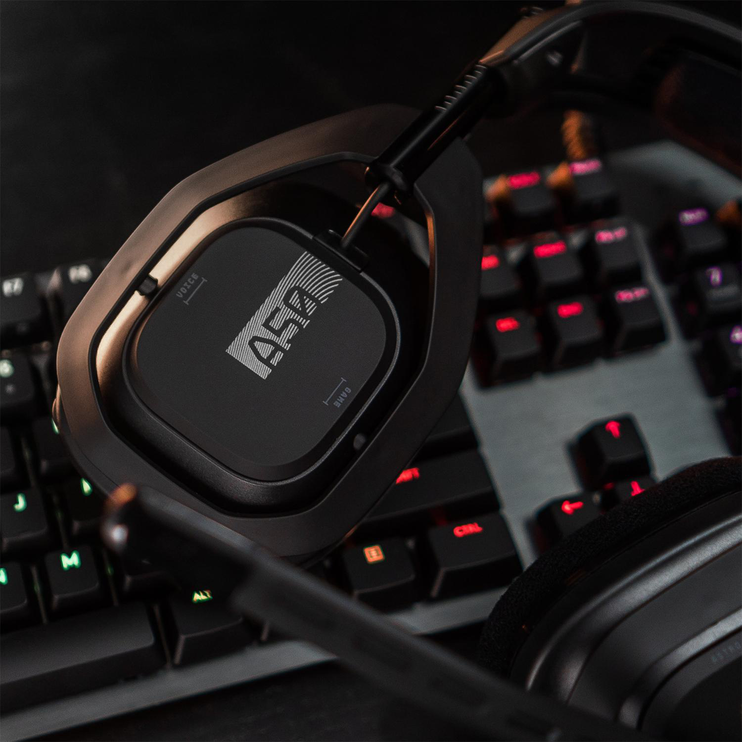 Schwarzes Gaming-Headset auf einer Tastatur. Das Headset ist zum Betrachter geneigt.