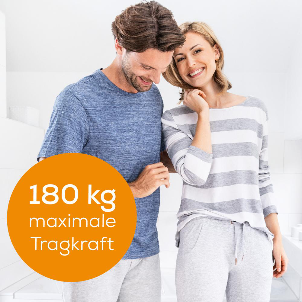 Ein lächelndes Paar steht nebeneinander, ein orangefarbener Kreis zeigt die maximale Tragkraft an.