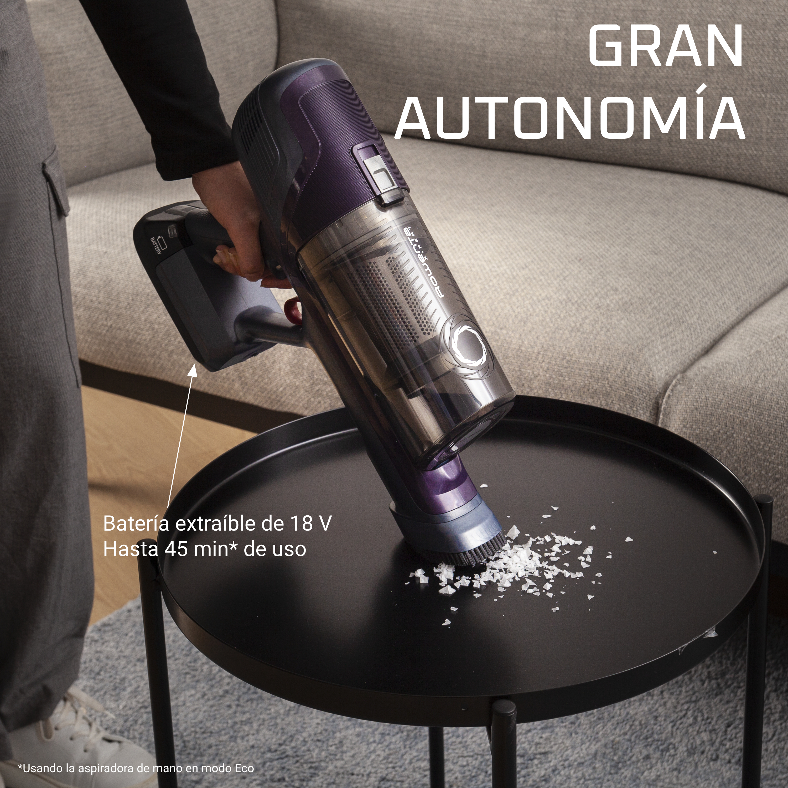 Aspiradora sobre una mesa negra con texto 'Gran Autonomía'.