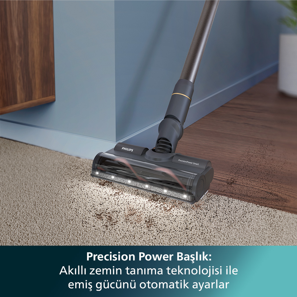 Halı üzerinde elektrikli süpürge başlığı, kir ve bir Philips logosu gösteriyor.