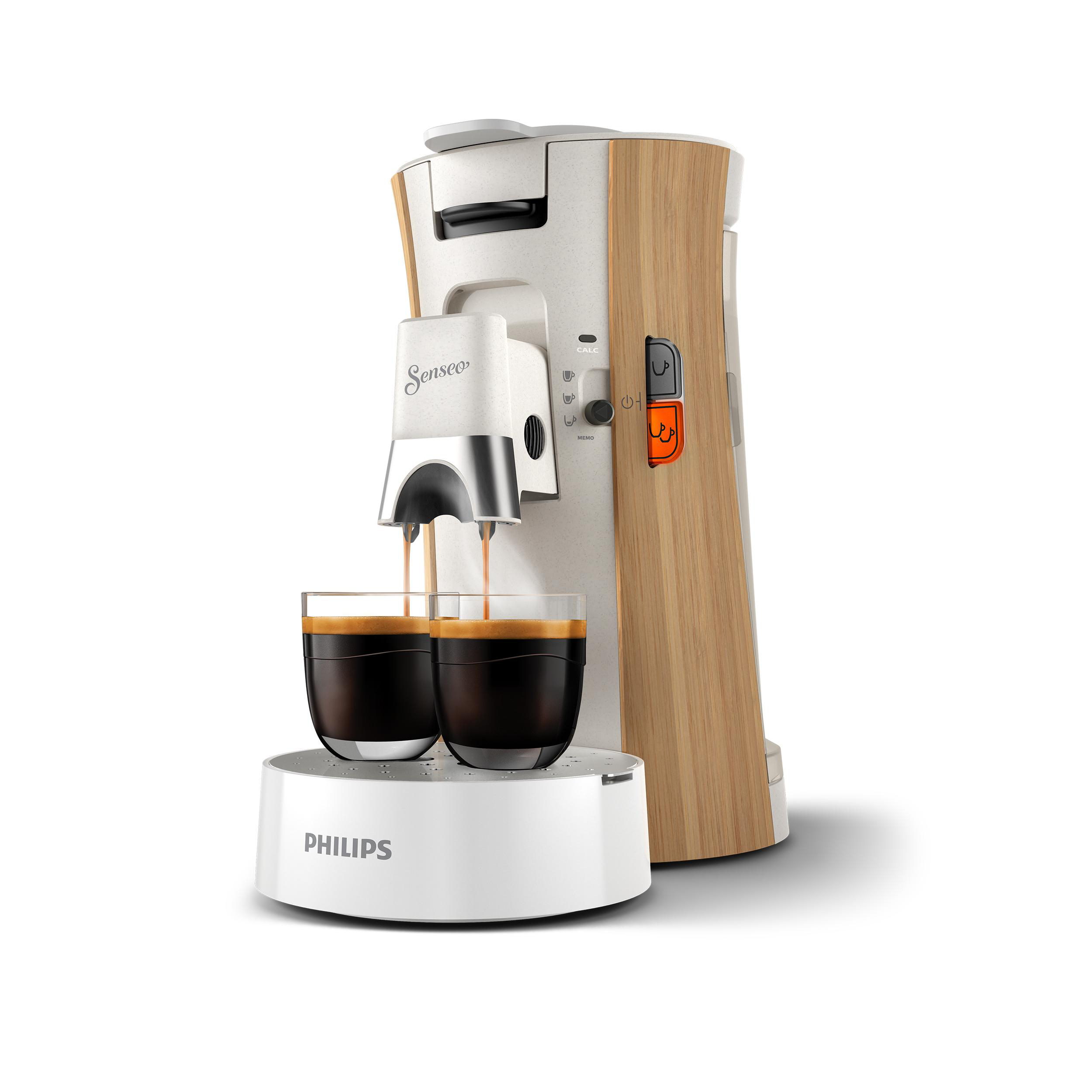 Kaffeemaschine, die Kaffee einschenkt. Sie ist weiß und holzfarben. Zwei Gläser stehen unter den Ausgüssen.