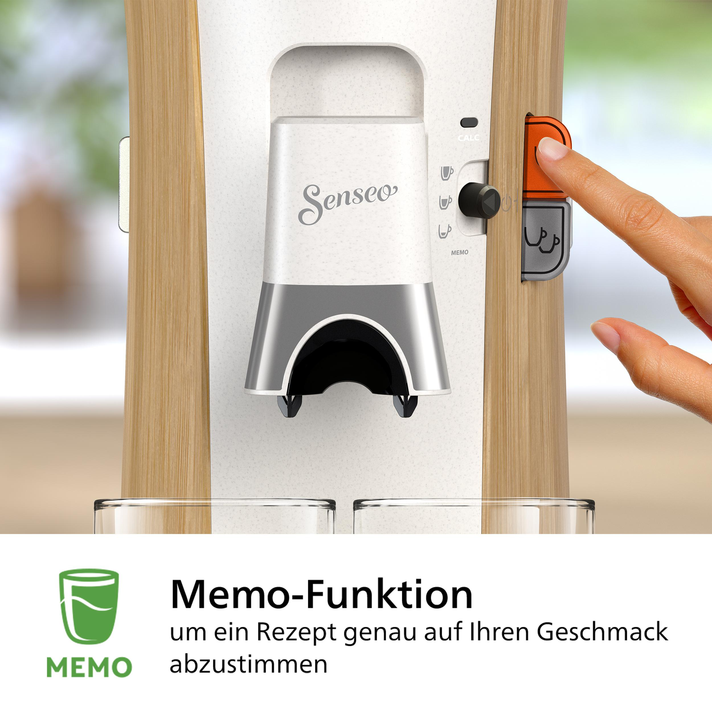 Kaffeemaschine, eine Hand drückt einen Knopf. Zwei Gläser darunter.
