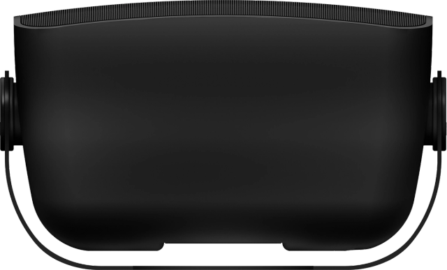 Fekete VR headset két kerek hangszóróval az oldalán. A készülék fekete felületen van.