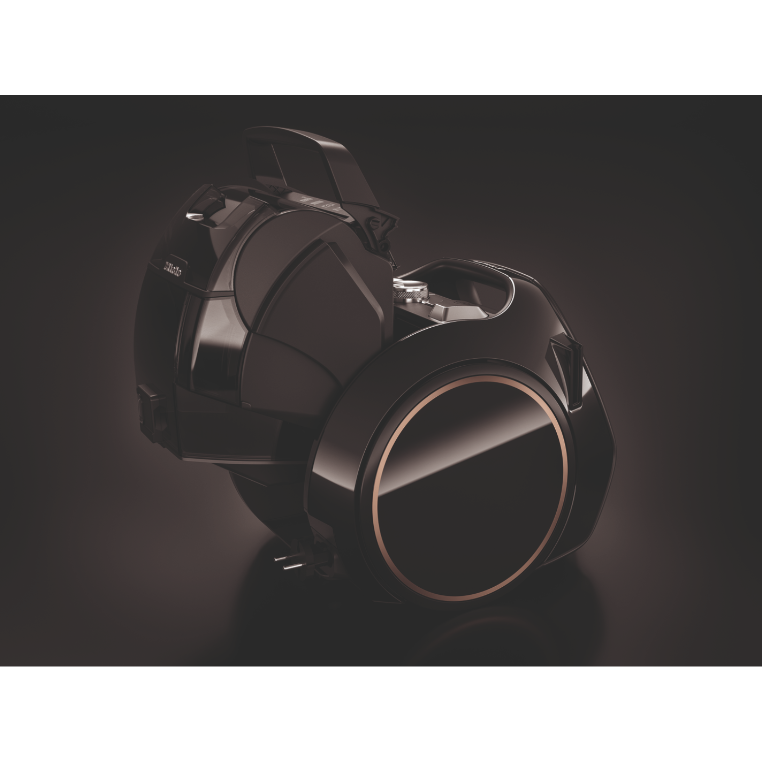 A black vacuum cleaner with gold accents on a dark surface. The lid is partially open.
