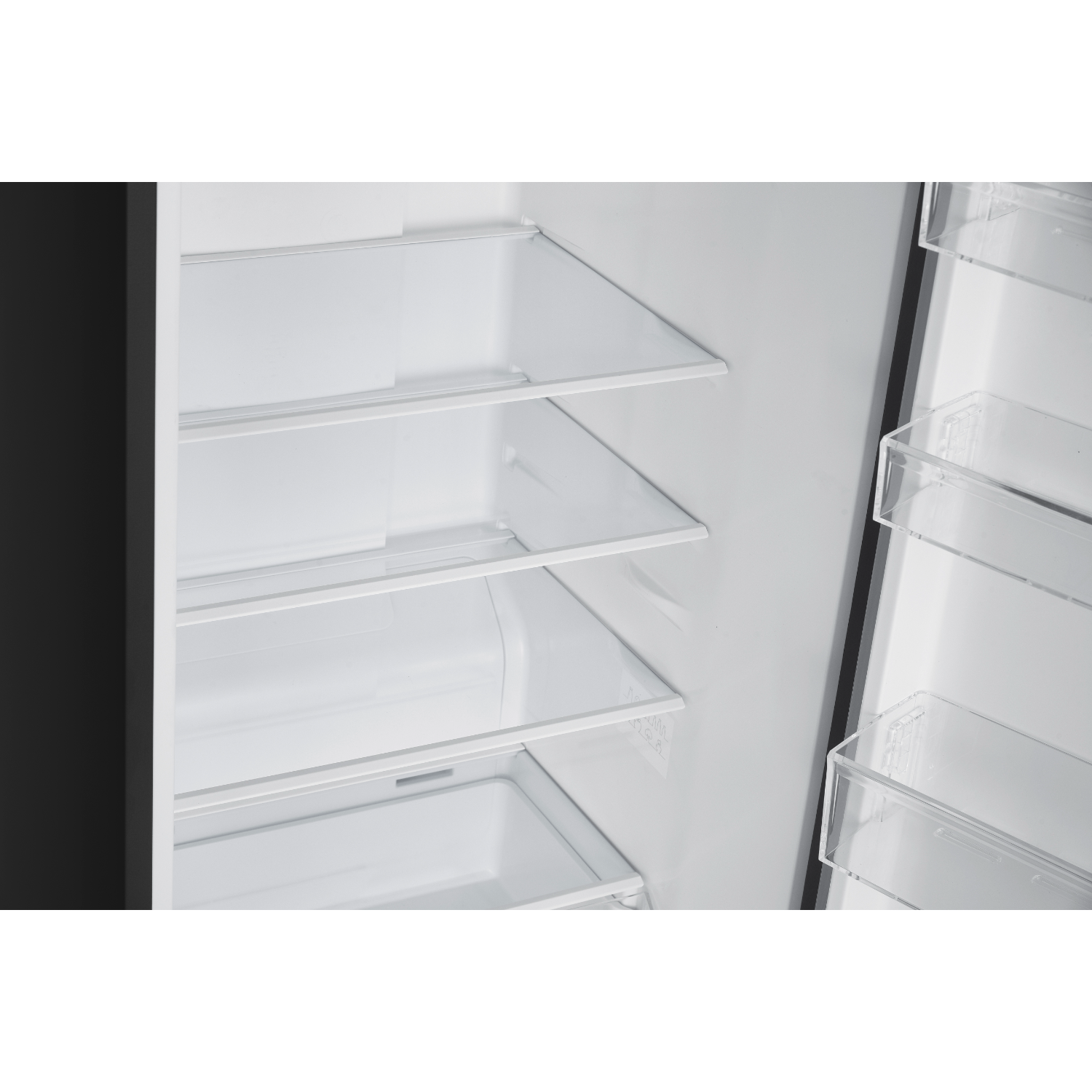 Inside view of a black refrigerator with glass shelves.