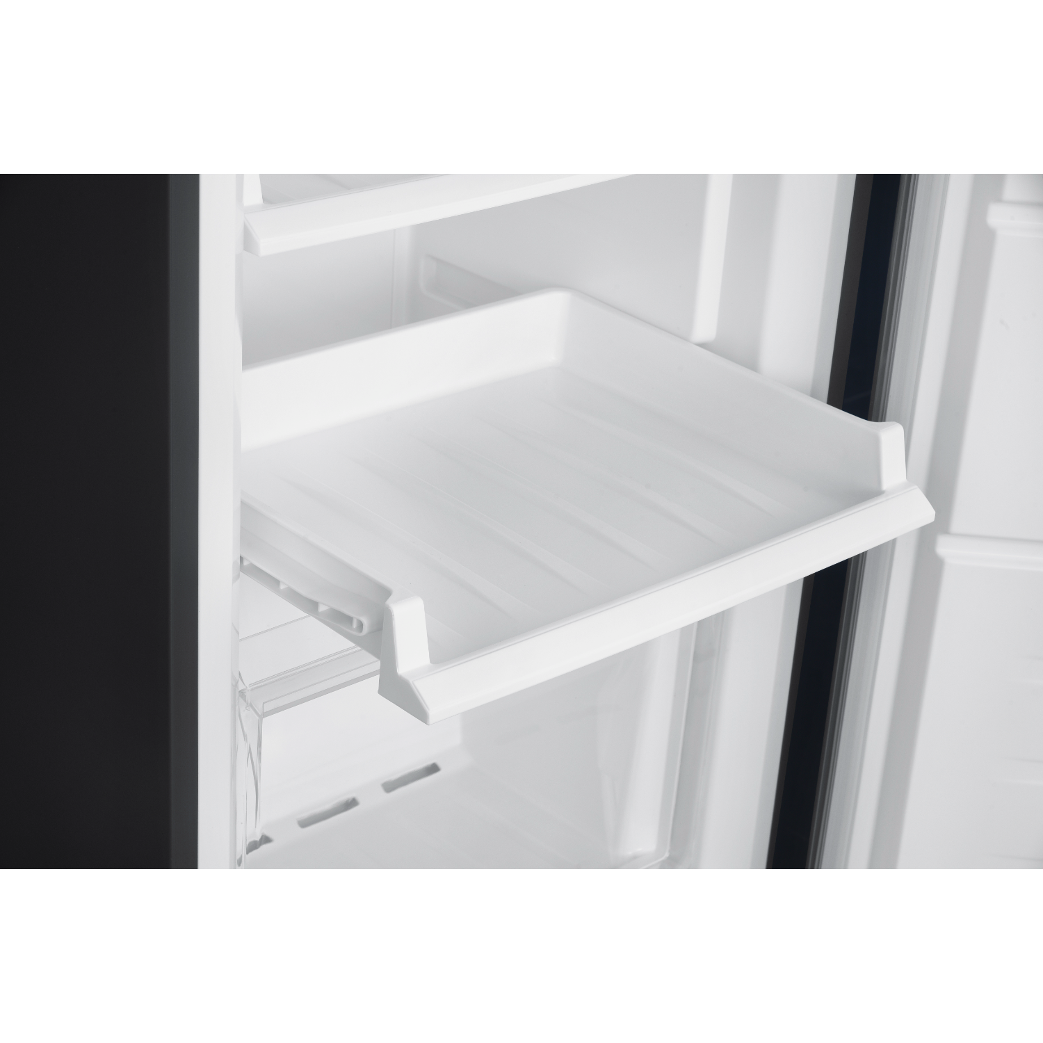 Refrigerator interior with white shelves and a transparent drawer. Black exterior visible.