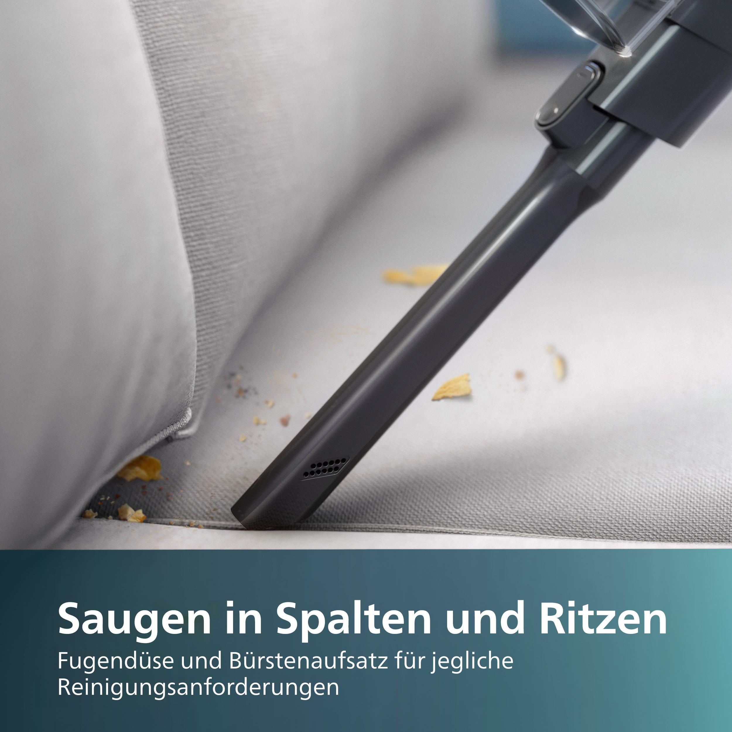 Staubsaugerdüse reinigt Sofa. Der Text lautet: 'Saugen in Spalten und Ritzen'.