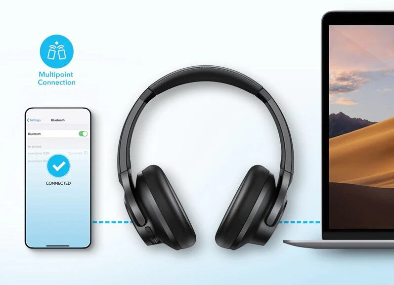 Słuchawki podłączone do telefonu i laptopa, z pustynnym tłem, pokazujące Bluetooth.