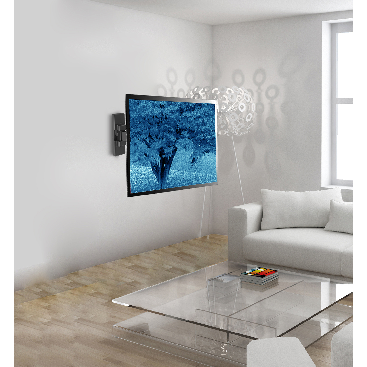 Living room with a TV mounted on the wall. A couch and a glass table are visible.