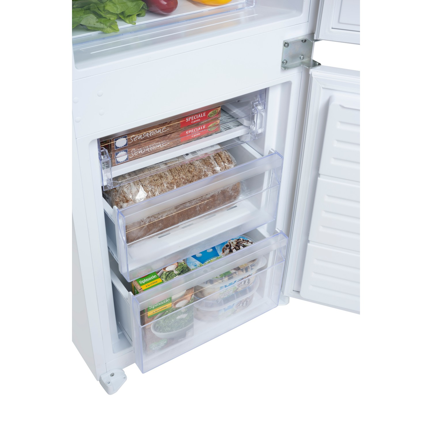 Interior view of a refrigerator with opened drawers containing food.