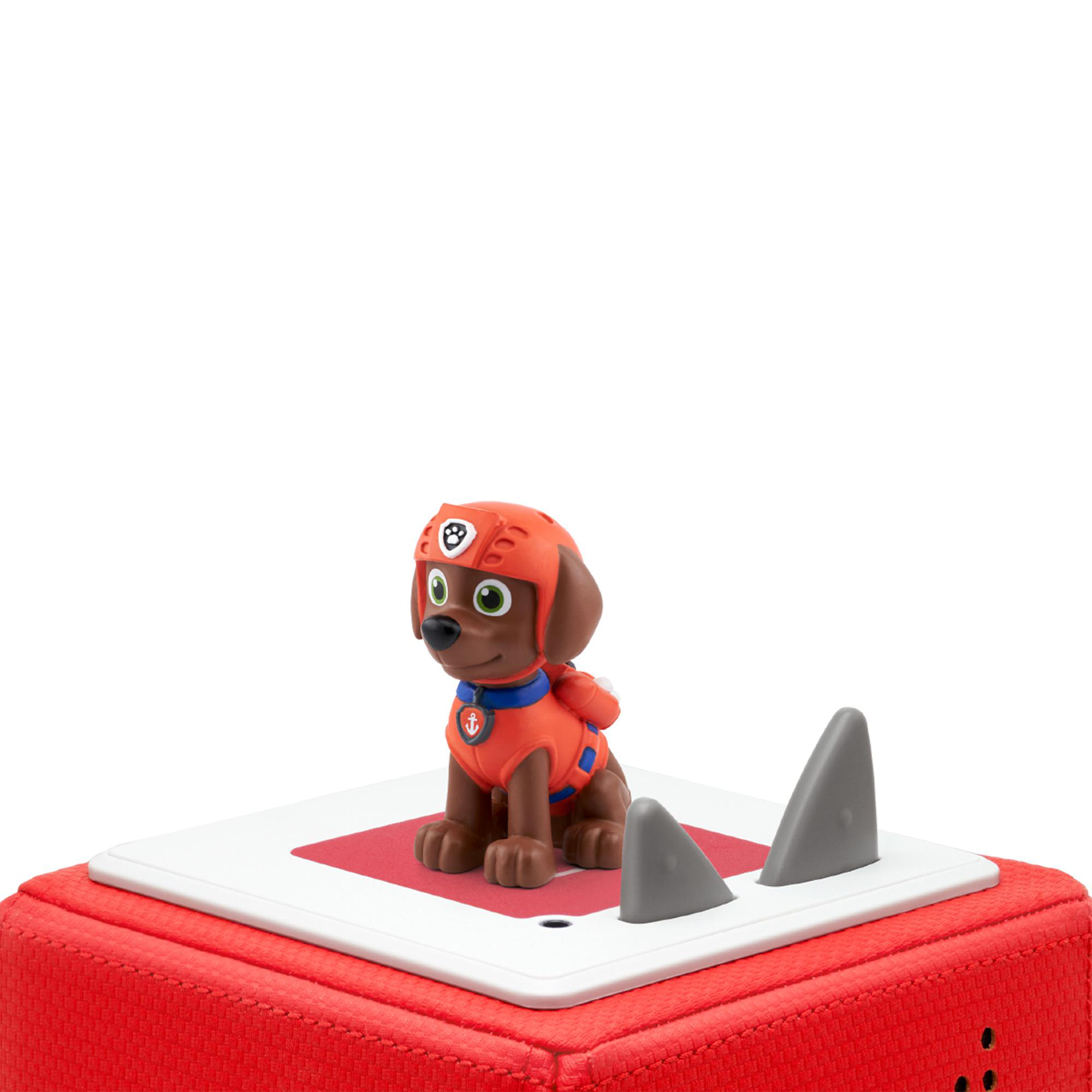 Ein Spielzeughund auf roter Basis mit Haifischflossen, ähnlich einem Paw Patrol-Charakter.